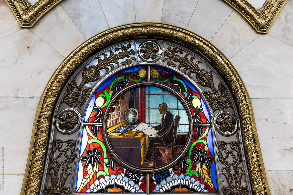 Detail of a stained glass art representing a scientist and world globe
