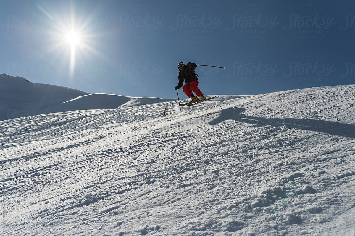 Man skiing in a bright sunny day