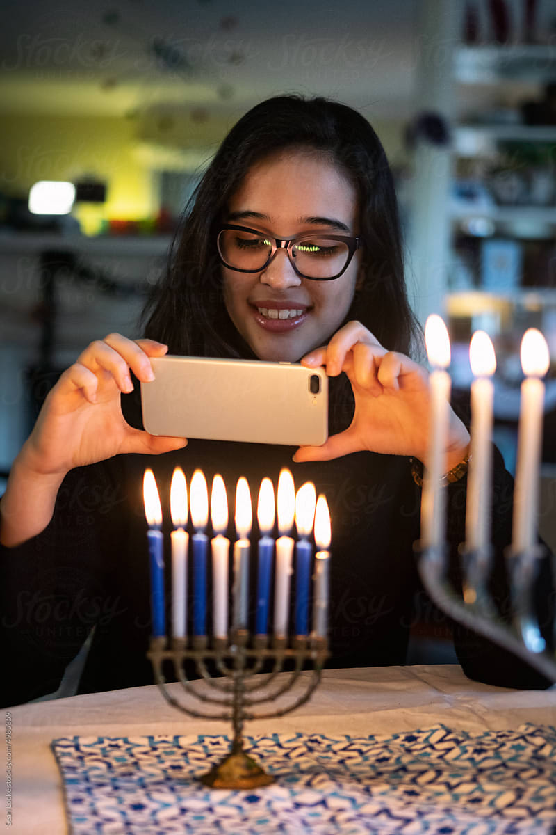 Hanukkah: Teen Girl Takes A Photo Of Menorah With Cell Phone