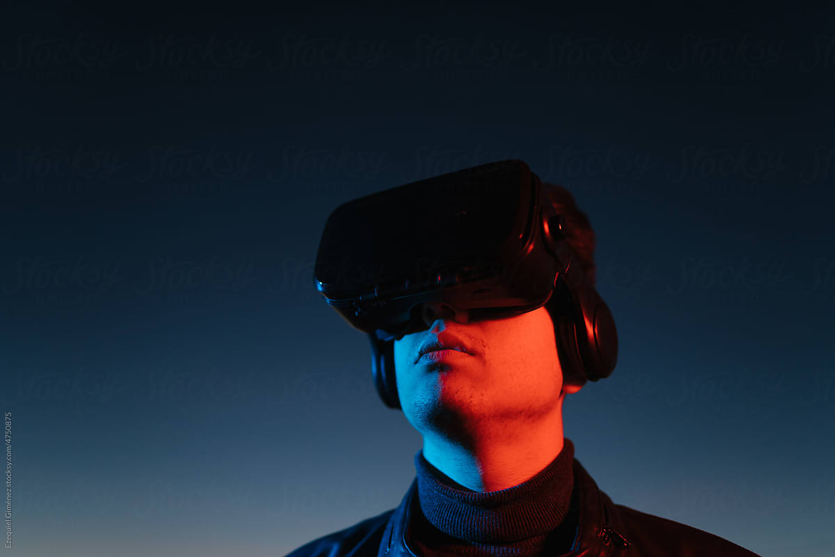 Male in VR helmet against sundown sky