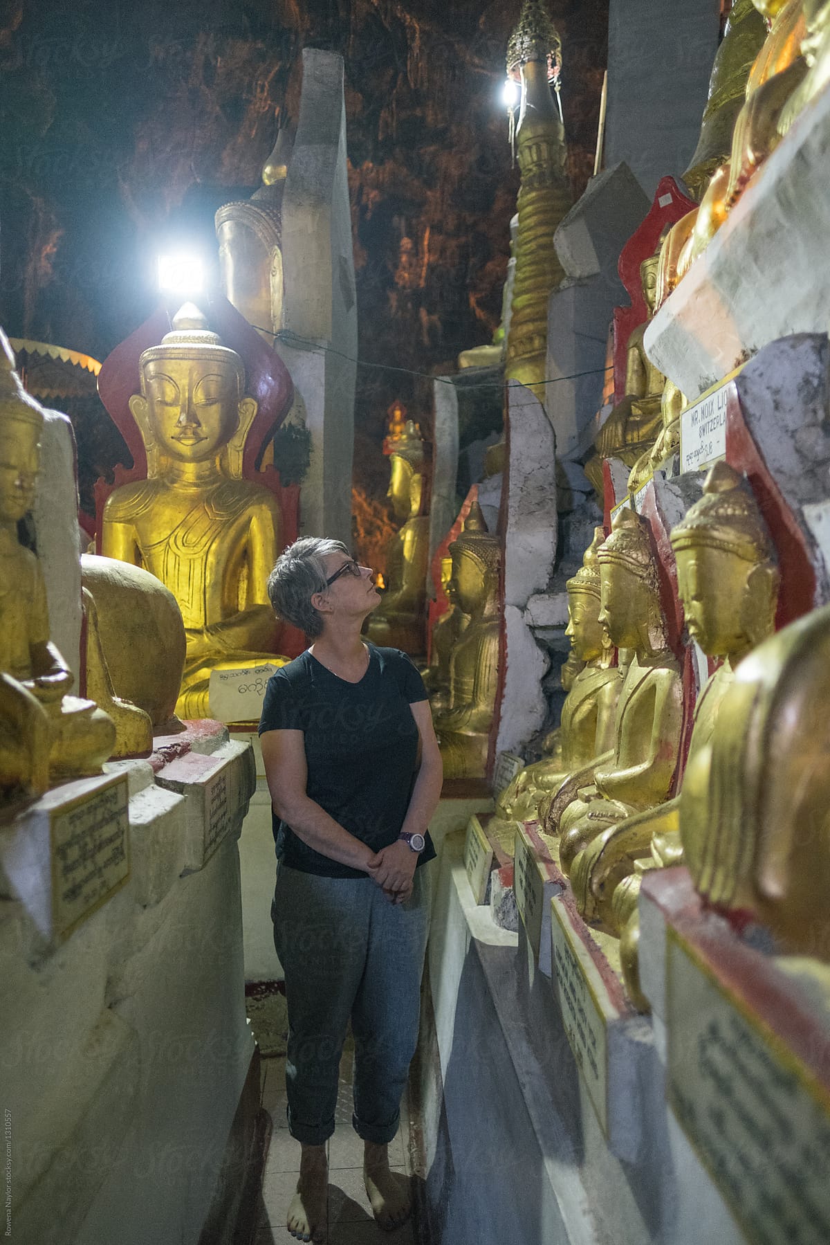 Tourist admiring some of the Buddha statues in the Pindaya Cave,