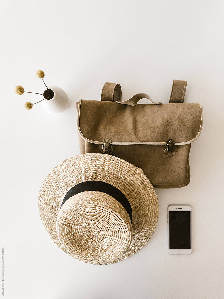 Smartphone and vase near hat and bag