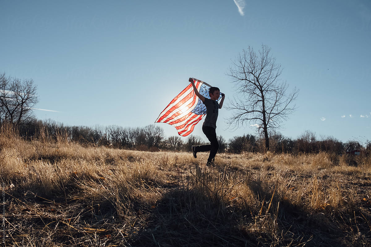 Child Running with American Flag Outdoors