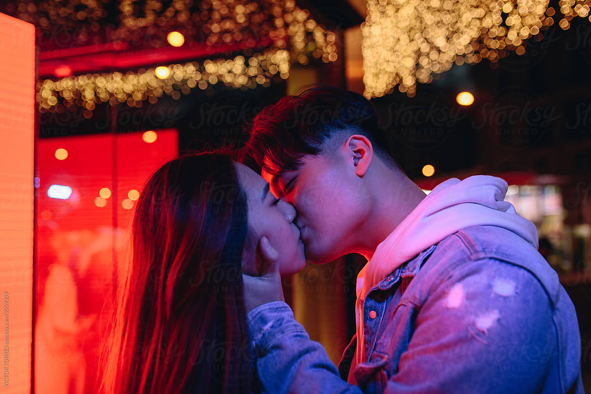 Chinese young couple kissing in street