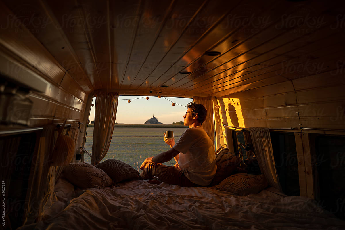 Man with coffee in camper van
