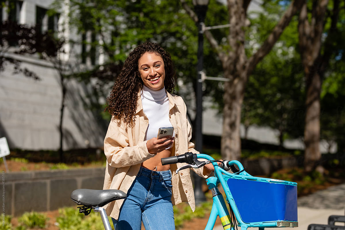 Happy Woman Uses App To Rent A City Bicycle