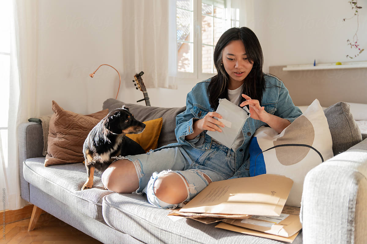 Girl With Dog, Opening E-commerce Postal Packages At Home.