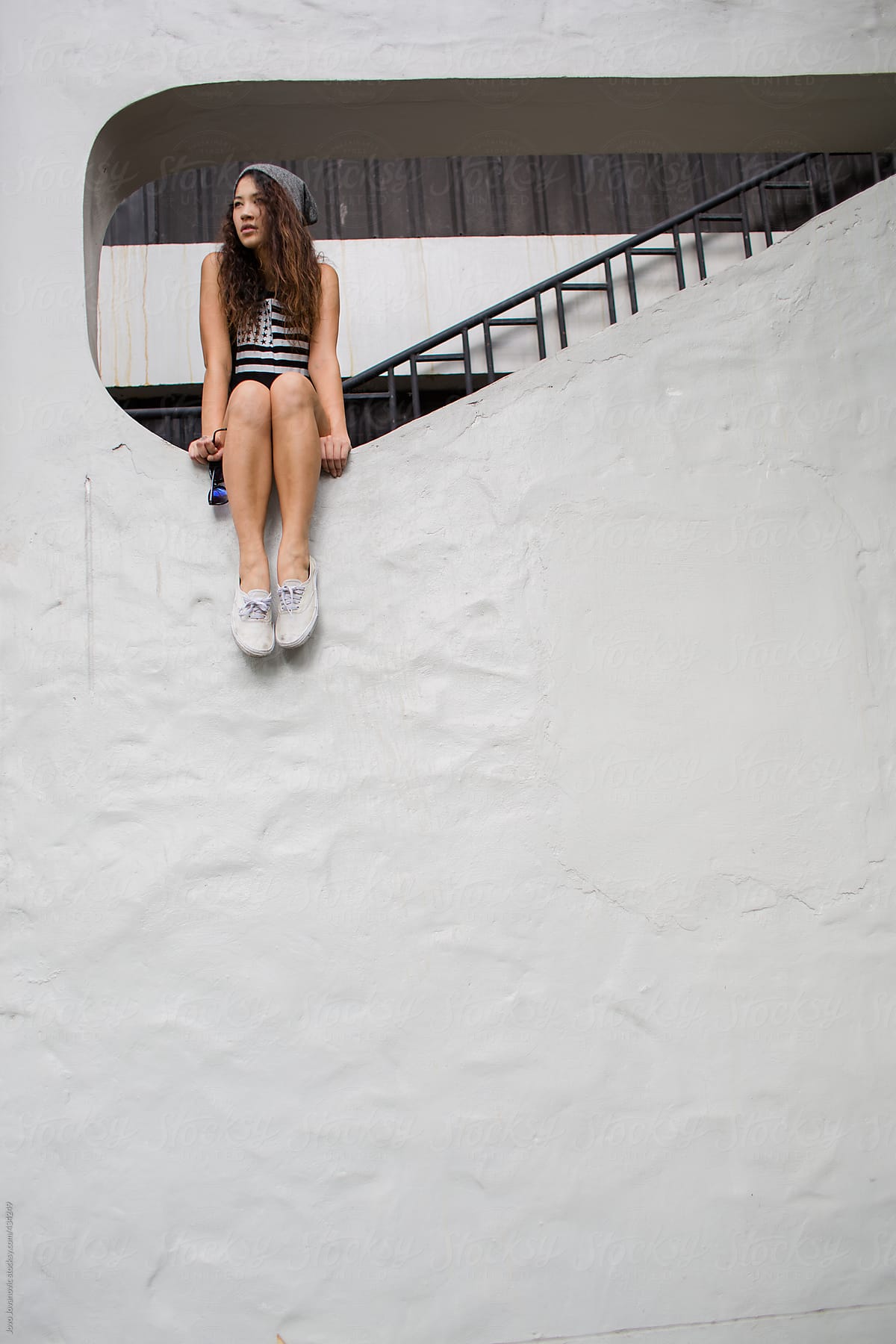 Young Woman Sitting Alone At The White Wall By Stocksy Contributor Jovo Jovanovic Stocksy