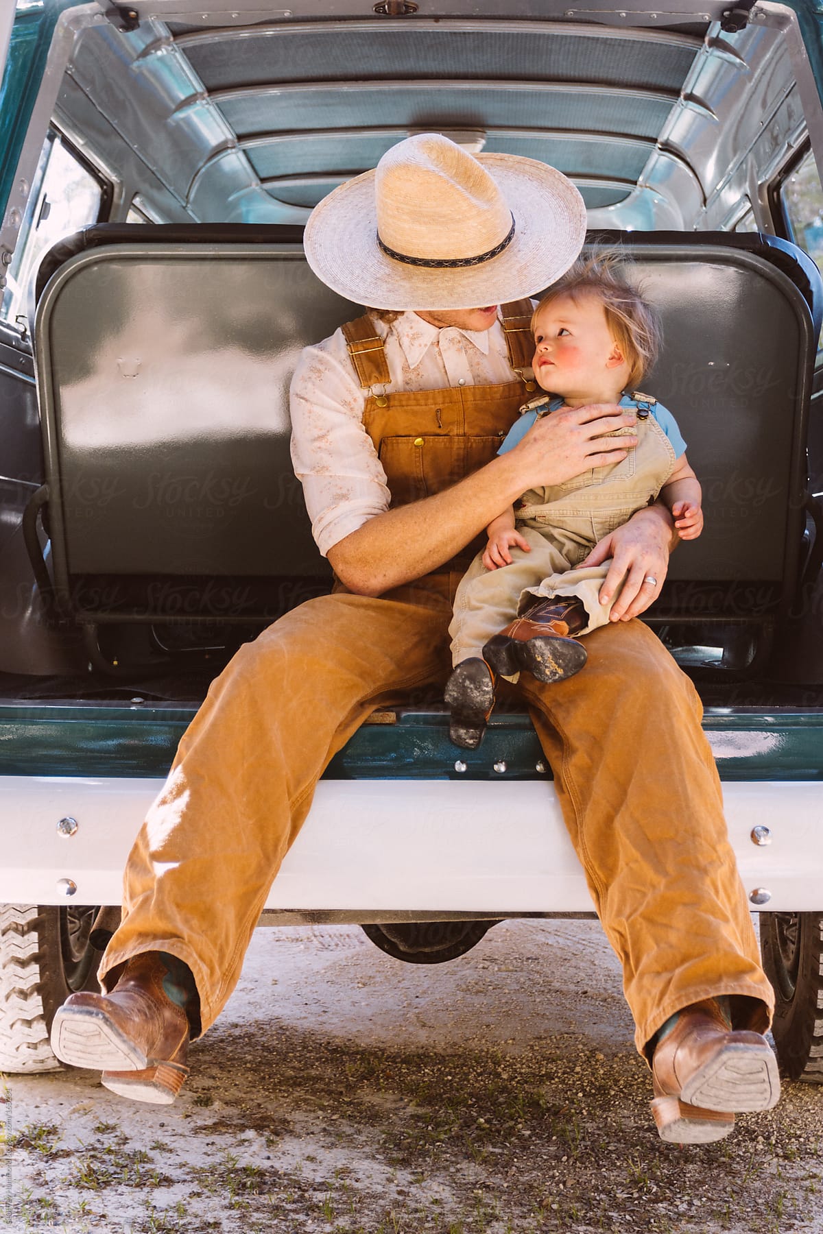 Father and Son in Back of Old Truck