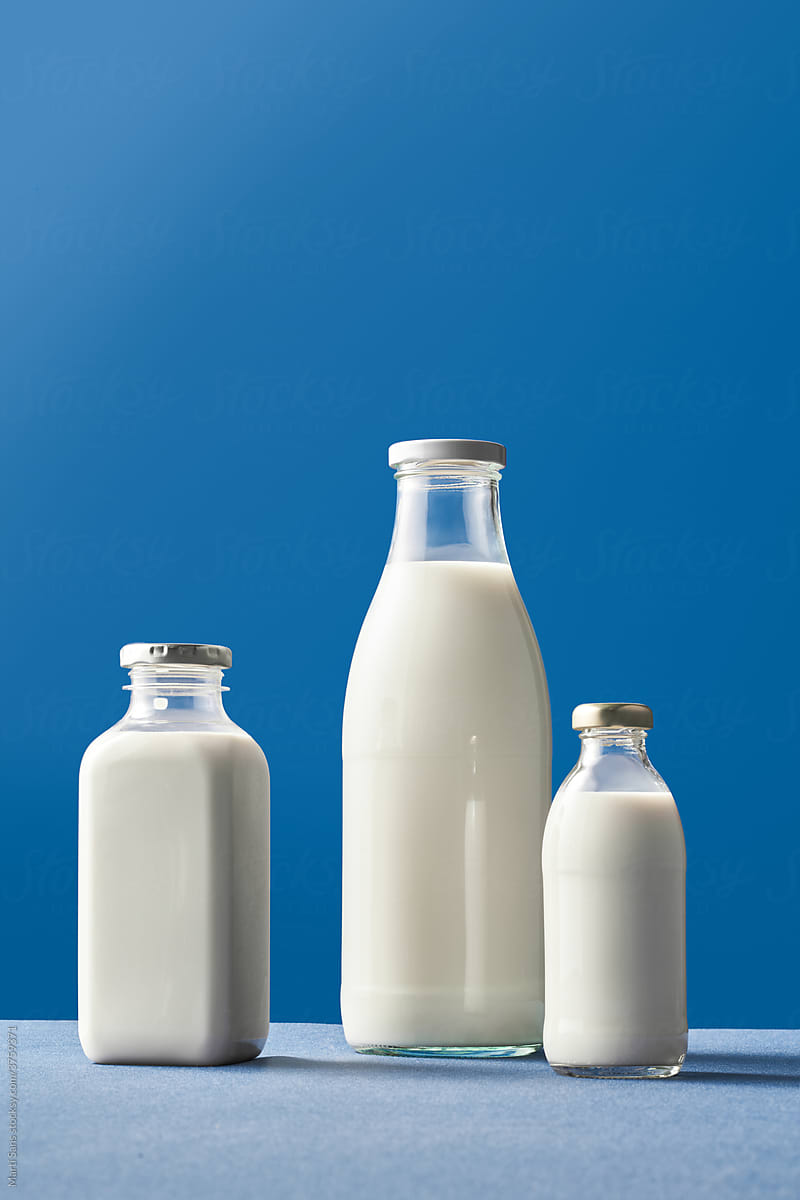 Milk bottles on blue background