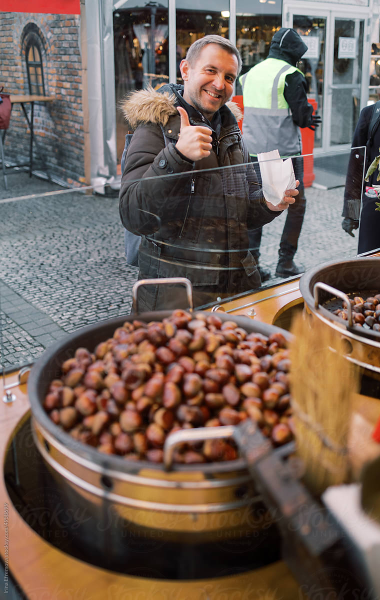 Man getting roasted chestnuts on the Christmas Market