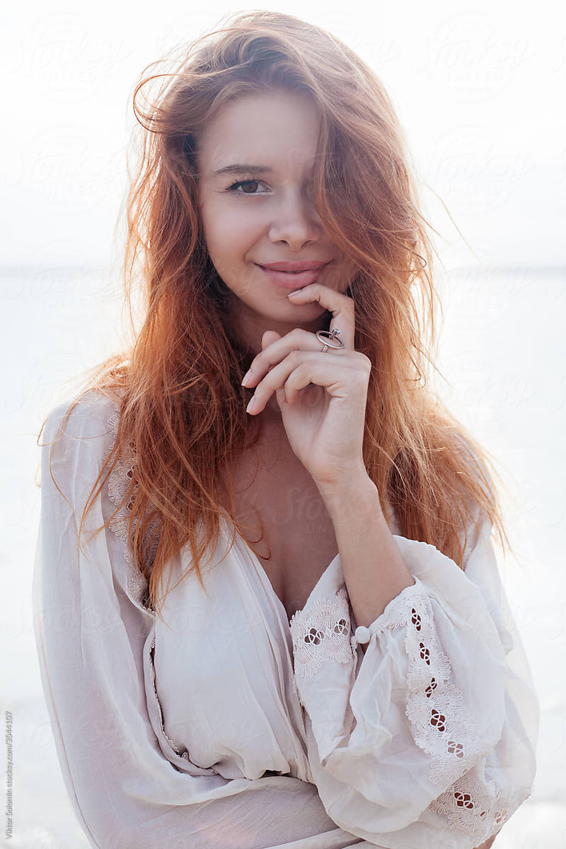Romantic young woman standing near sea