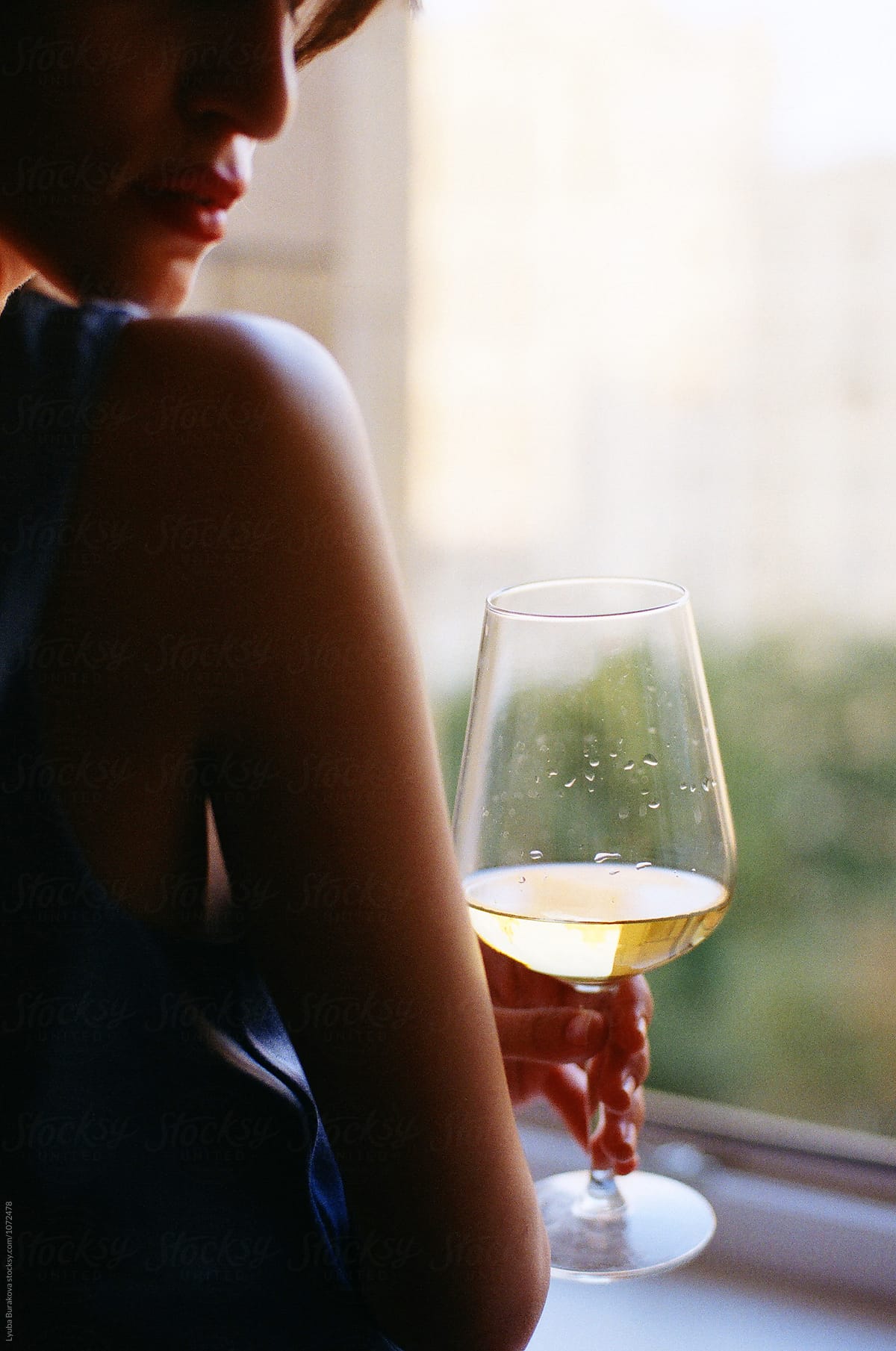 Woman Holding Glass Of White Wine Del Colaborador De Stocksy Amor Burakova Stocksy 