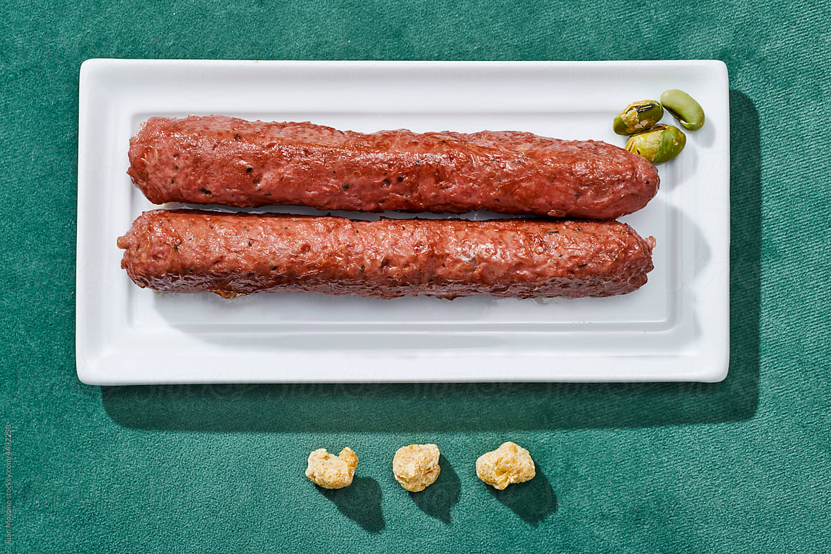 pair of fried veggie sausages in a rectangular plate