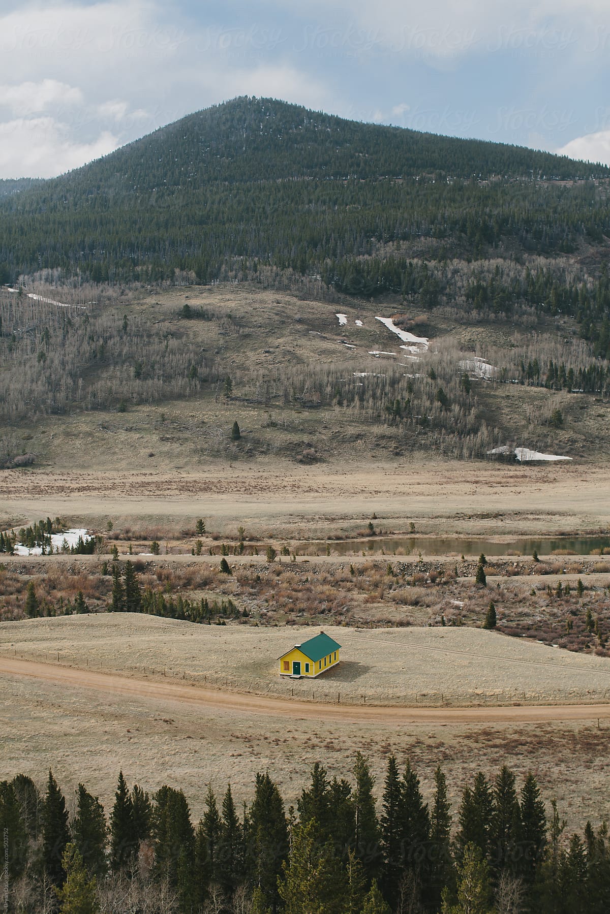 Yellow house in mountain valley