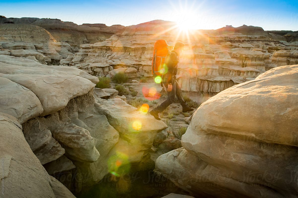 Man Backpacking in Bisti Badlands Wilderness Area New Mexico at Sunrise