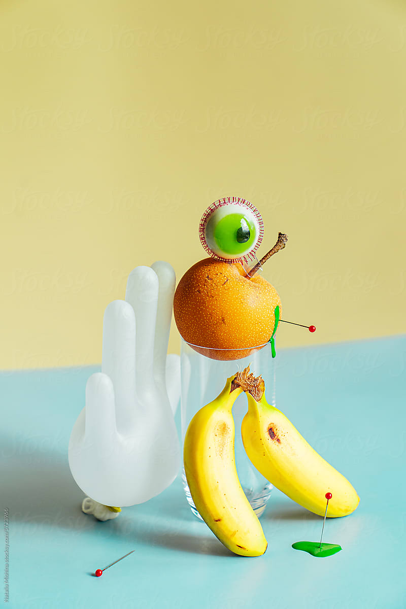 A composition with a rubber glove and a candy in the form of an eye.