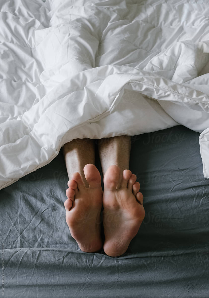 Feet of a guy in bed