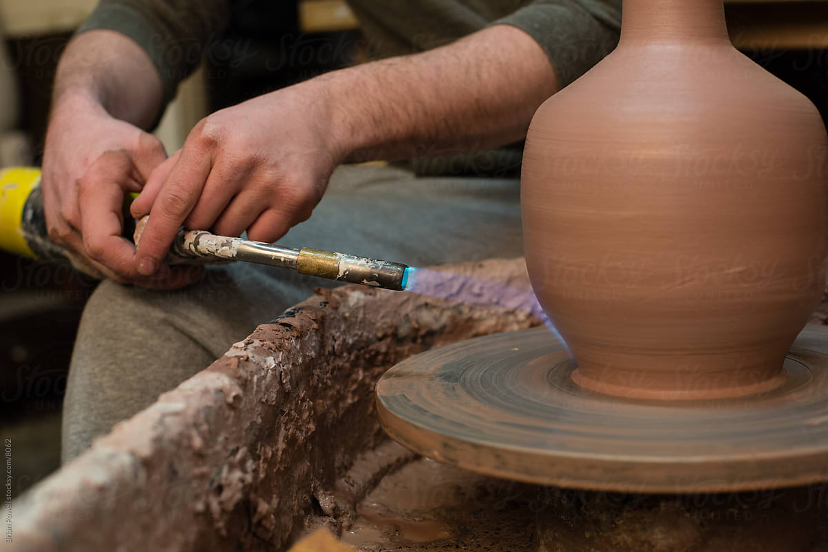 potter finishes a vase