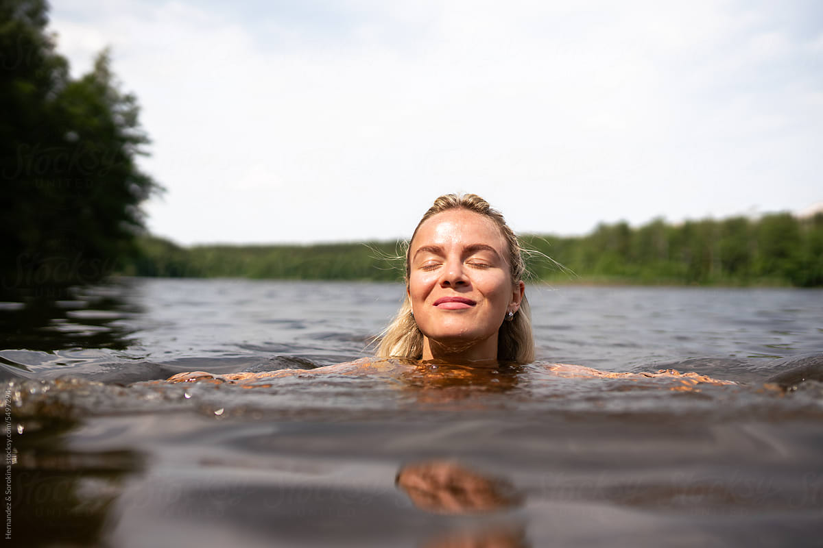 Woman Swimming In The Lake In Summer