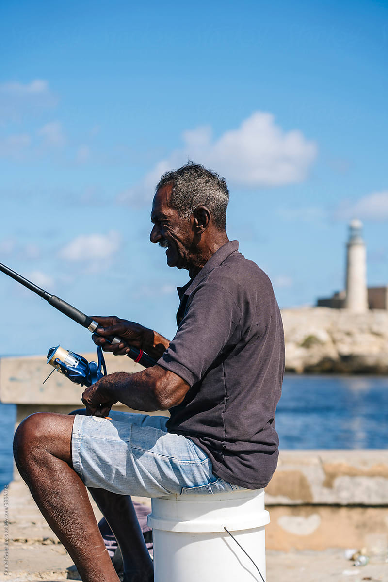 Aged attentive fisher man catching fish in Cuba