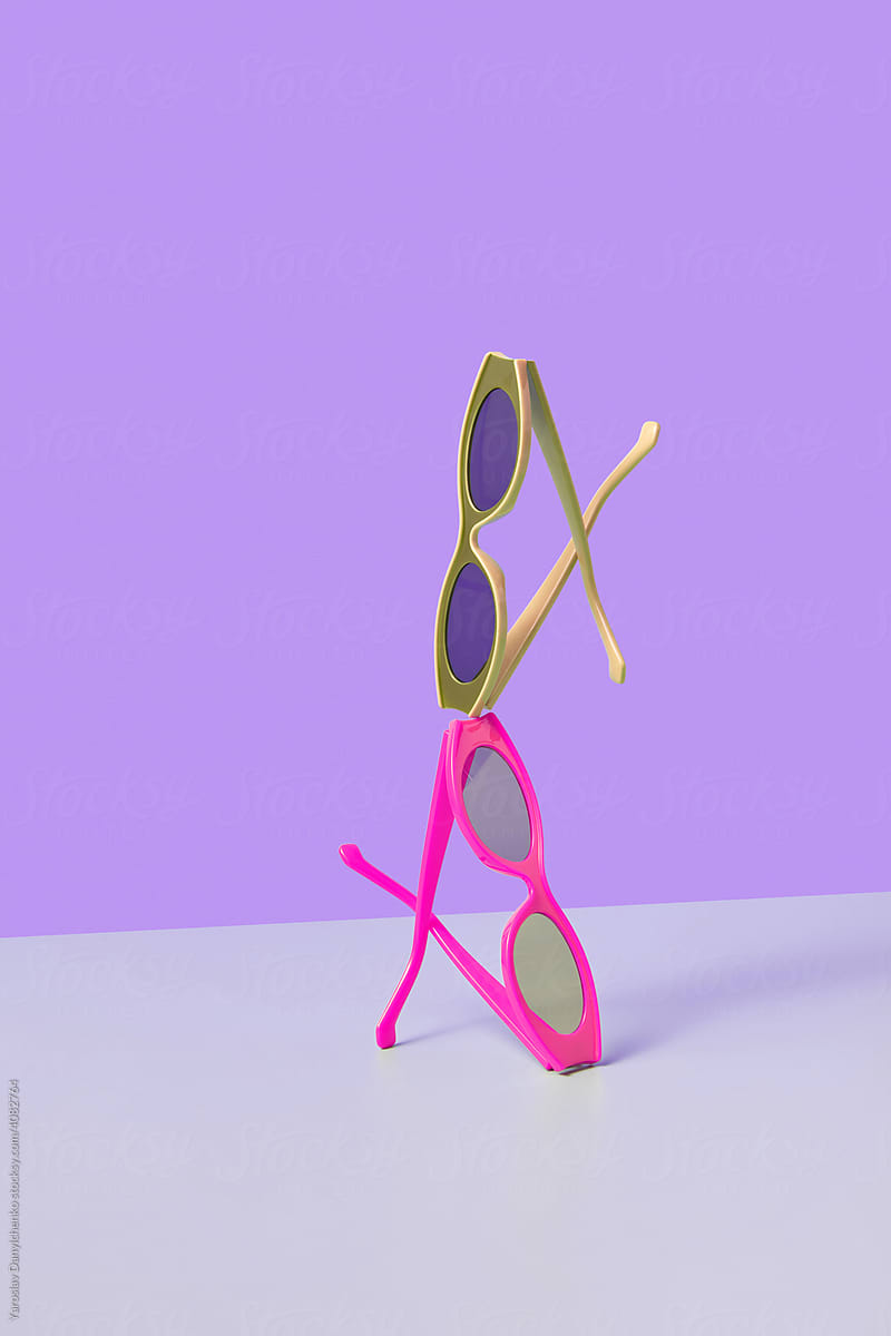 Two sunglasses balancing on duotone background