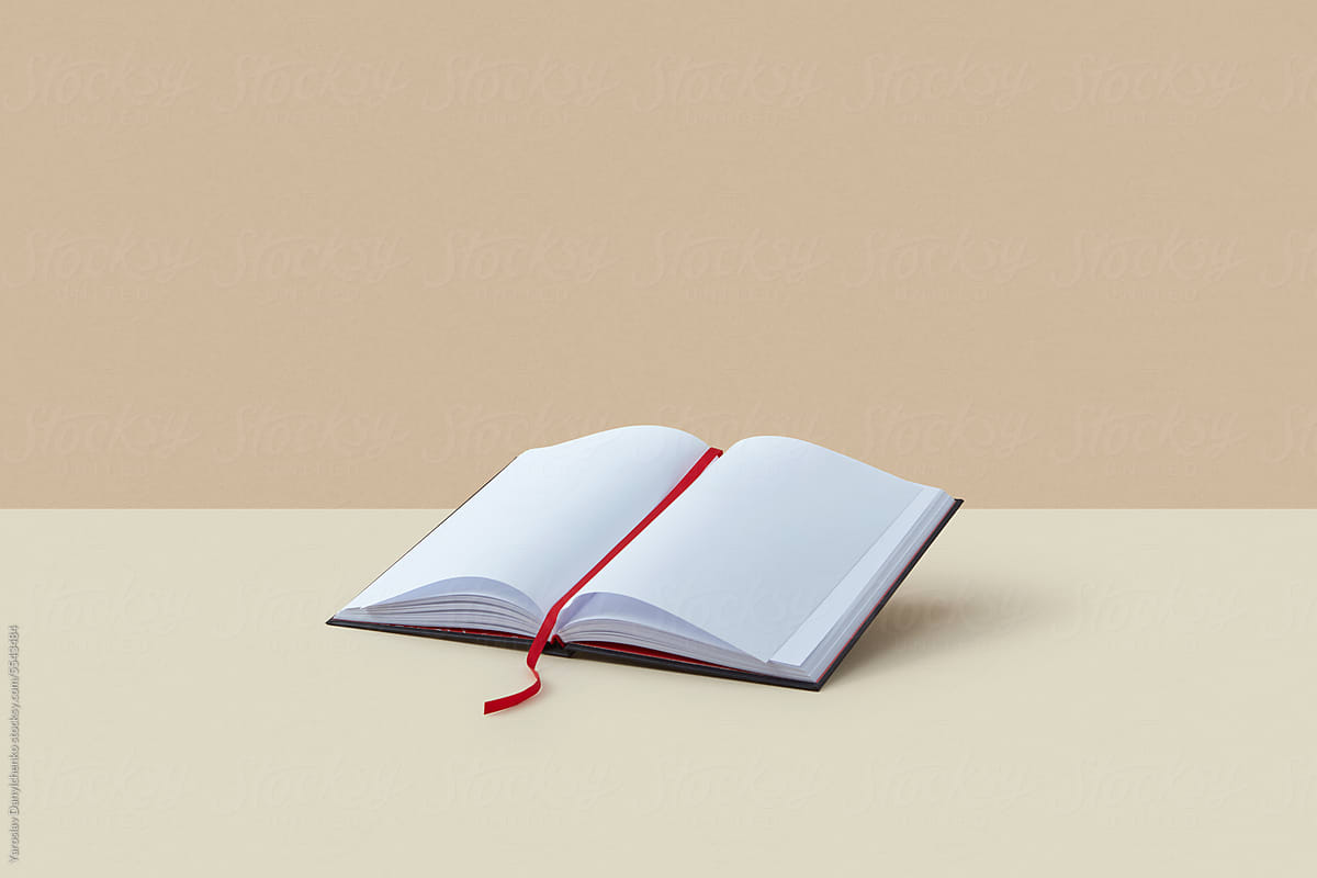 Open blank book with red bookmark.