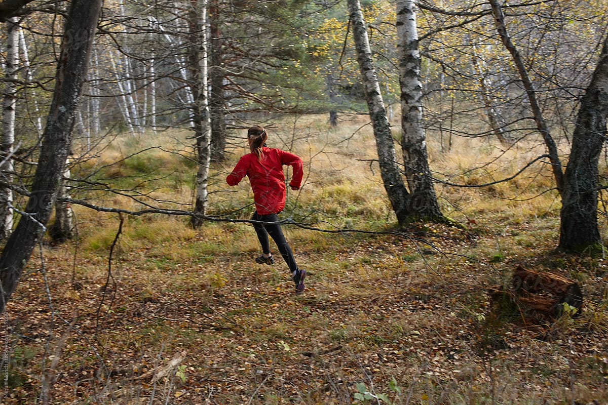 Young woman running in the forest