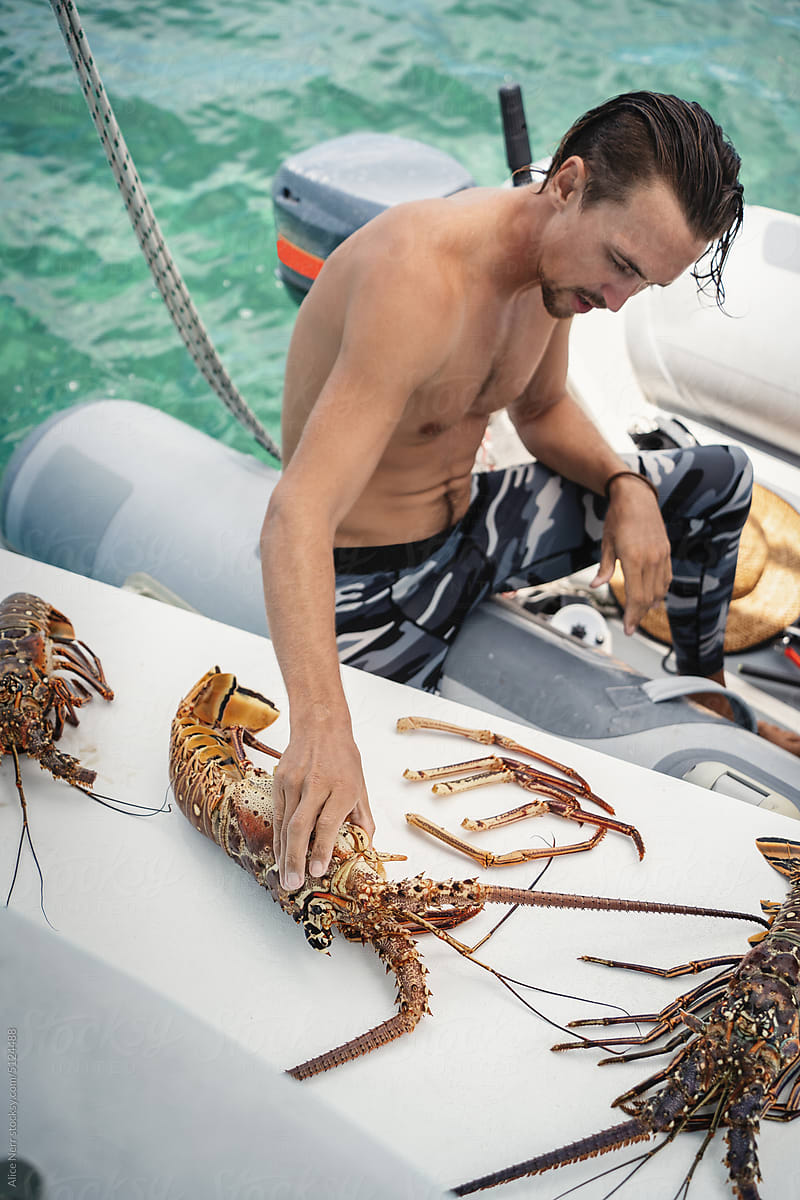 Sailor shows his catch of lobsters