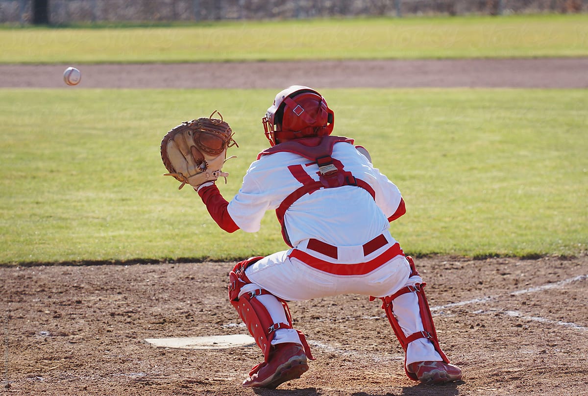 A catcher prepares to catch a baseball pitched to him