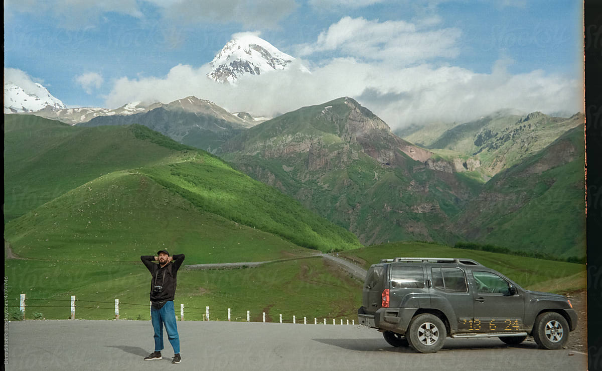 A traveler photographer enjoys a trip in the beautiful mountains