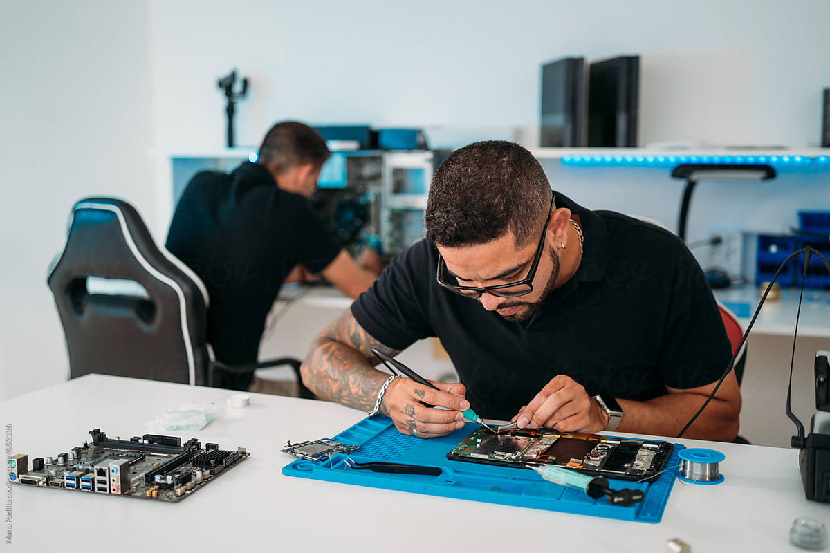 Male employee fixing modern gadget