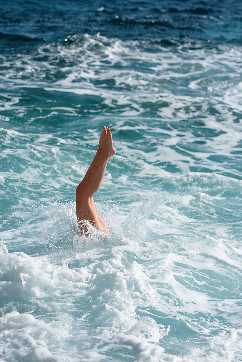 Unrecognizable woman plunging in sea