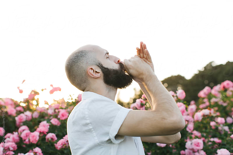 Young Bearded Man with Flowers Making a Whistling Noise