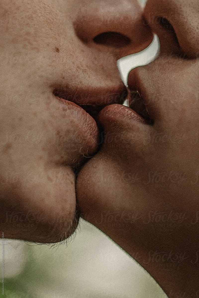 Close up photo of couple in love is kissing each other