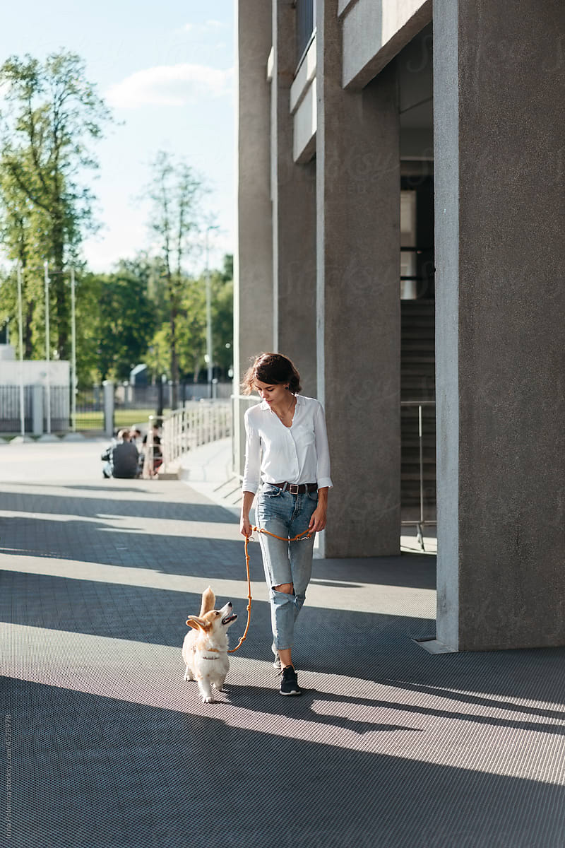 Woman with dog on walk.