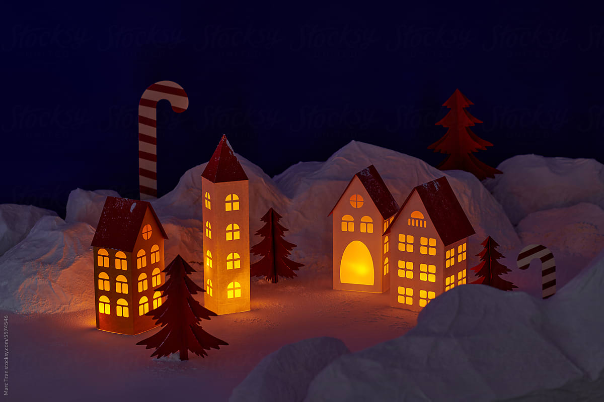 Snowfall in winter village made of paper