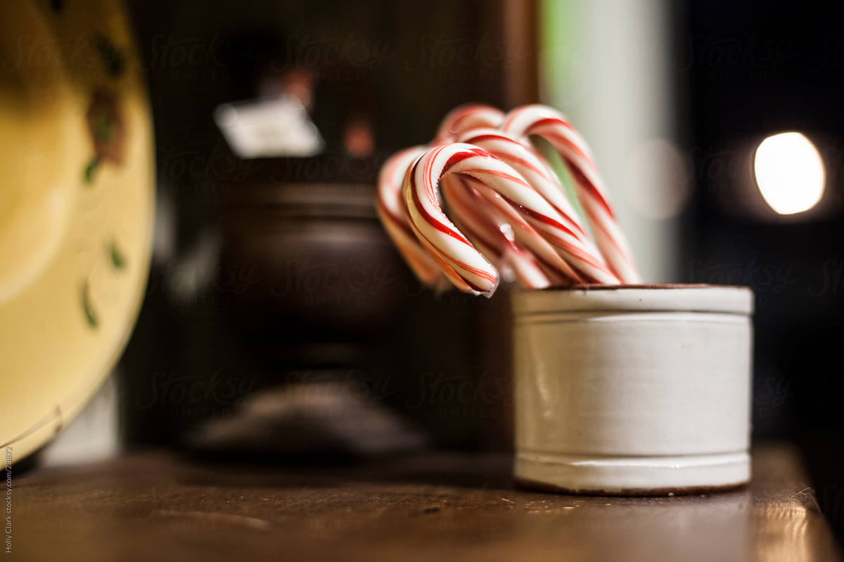 Group of red and white candy canes in rustick container