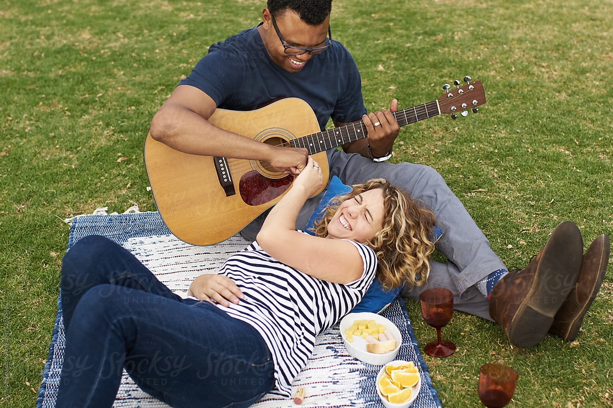 Couple Teasing Each Other On A Picnic By Stocksy Contributor Per Images Stocksy