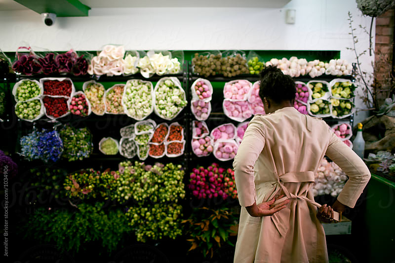 Woman shopping for flowers in flower shop