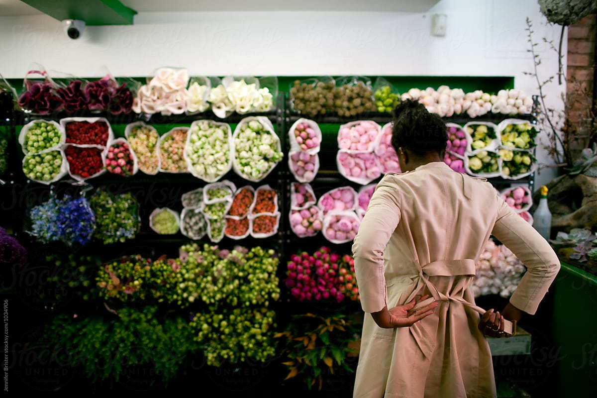 Woman shopping for flowers in flower shop