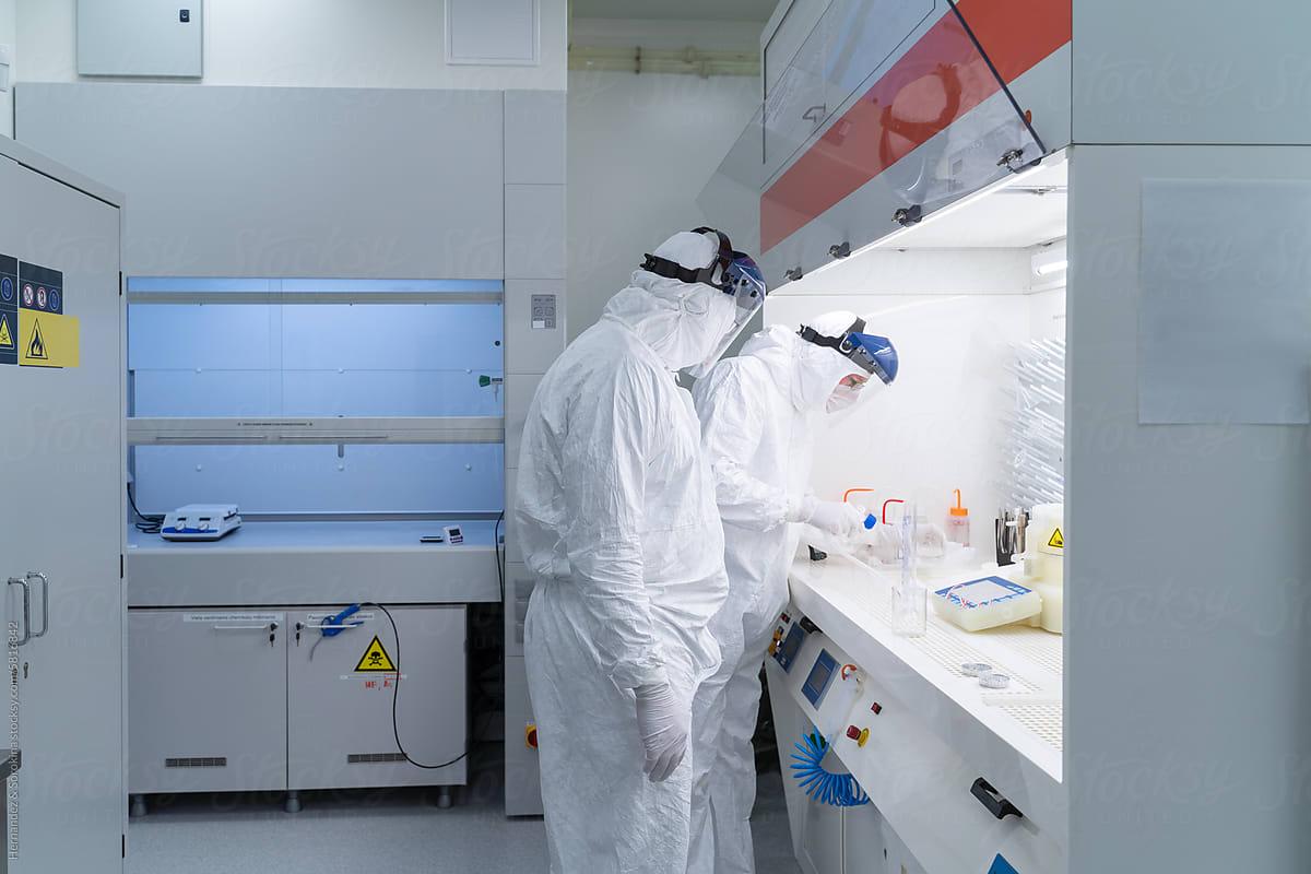 Two Scientists Working In Chamber At Clean Room