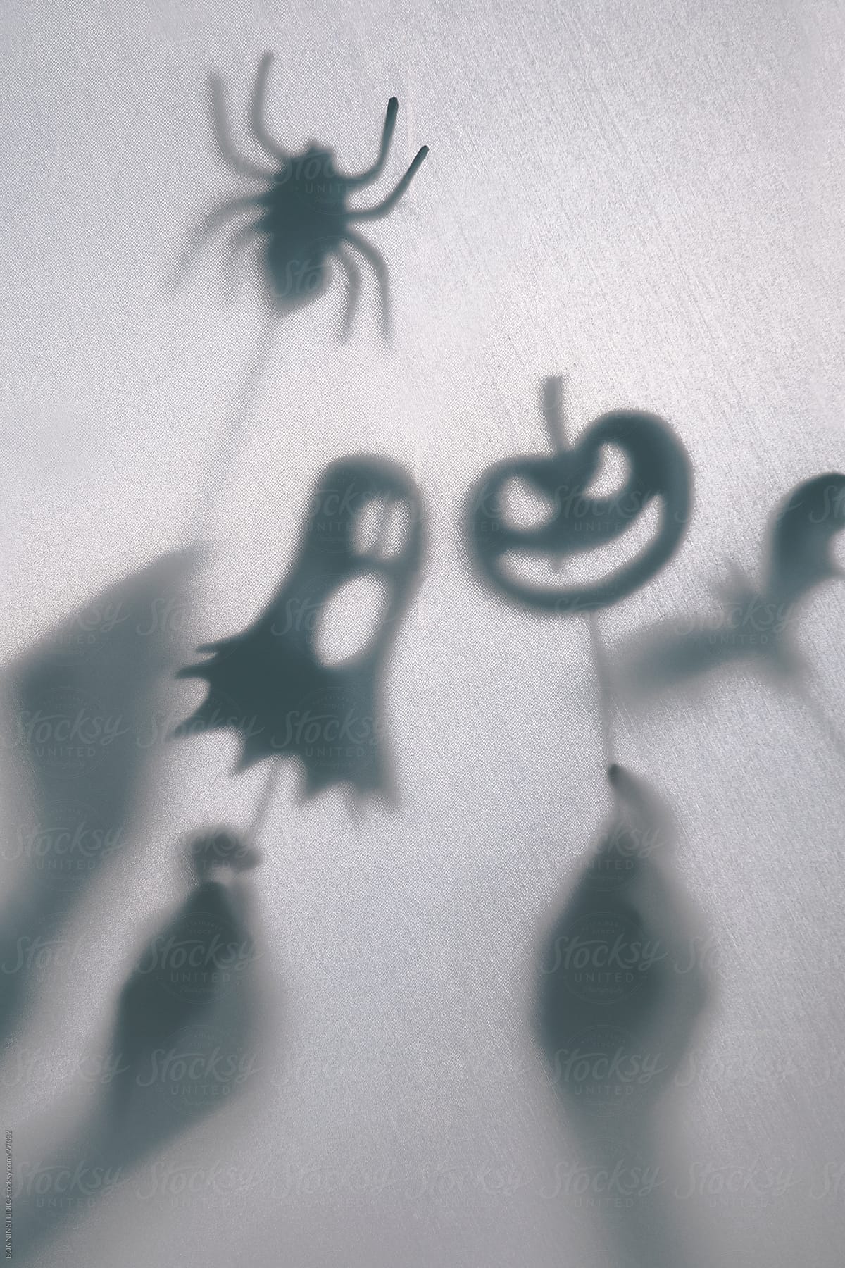 Halloween decoration. Children making terrifying shadow puppets.