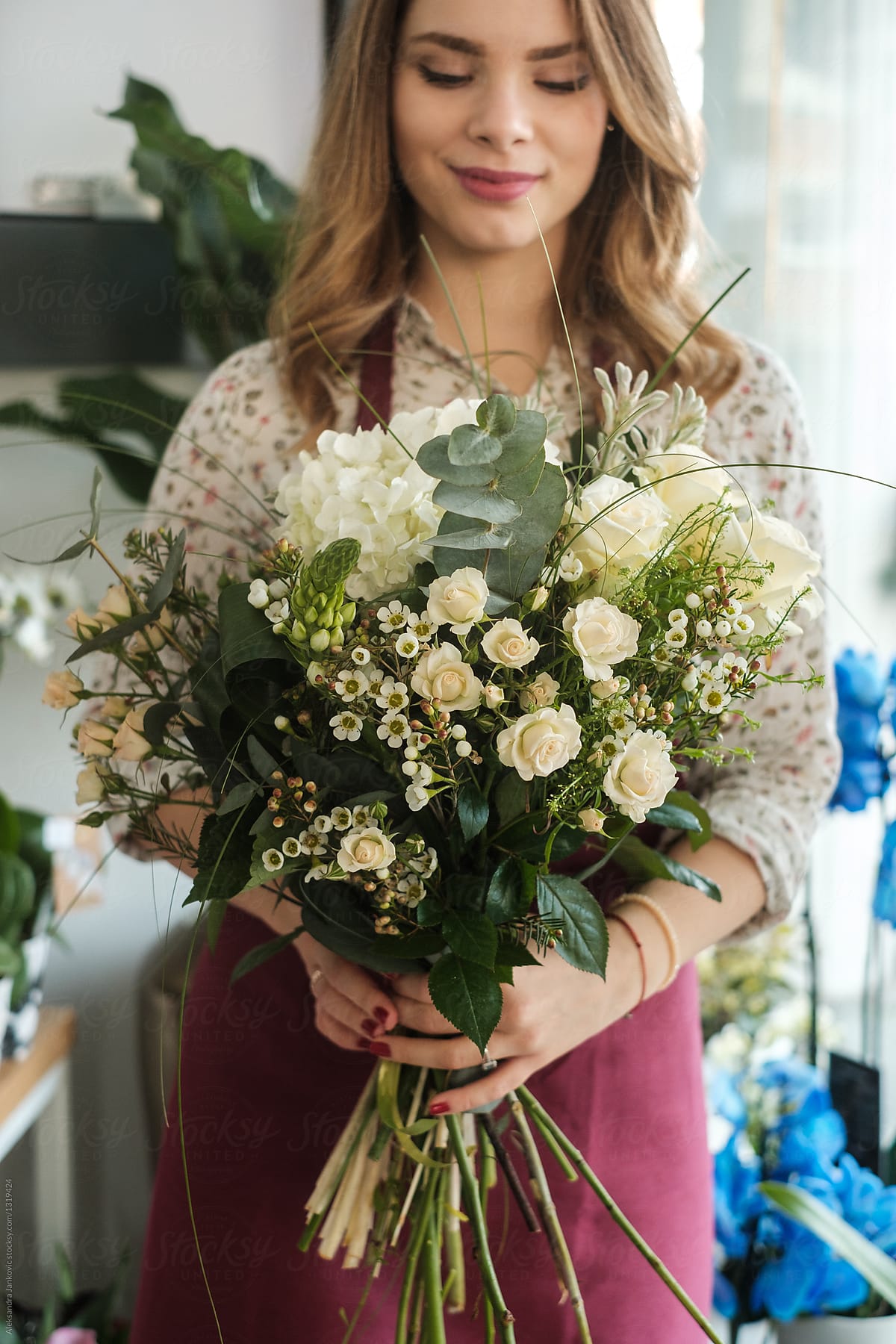 Smiling Female Florist Holding A Bouquet