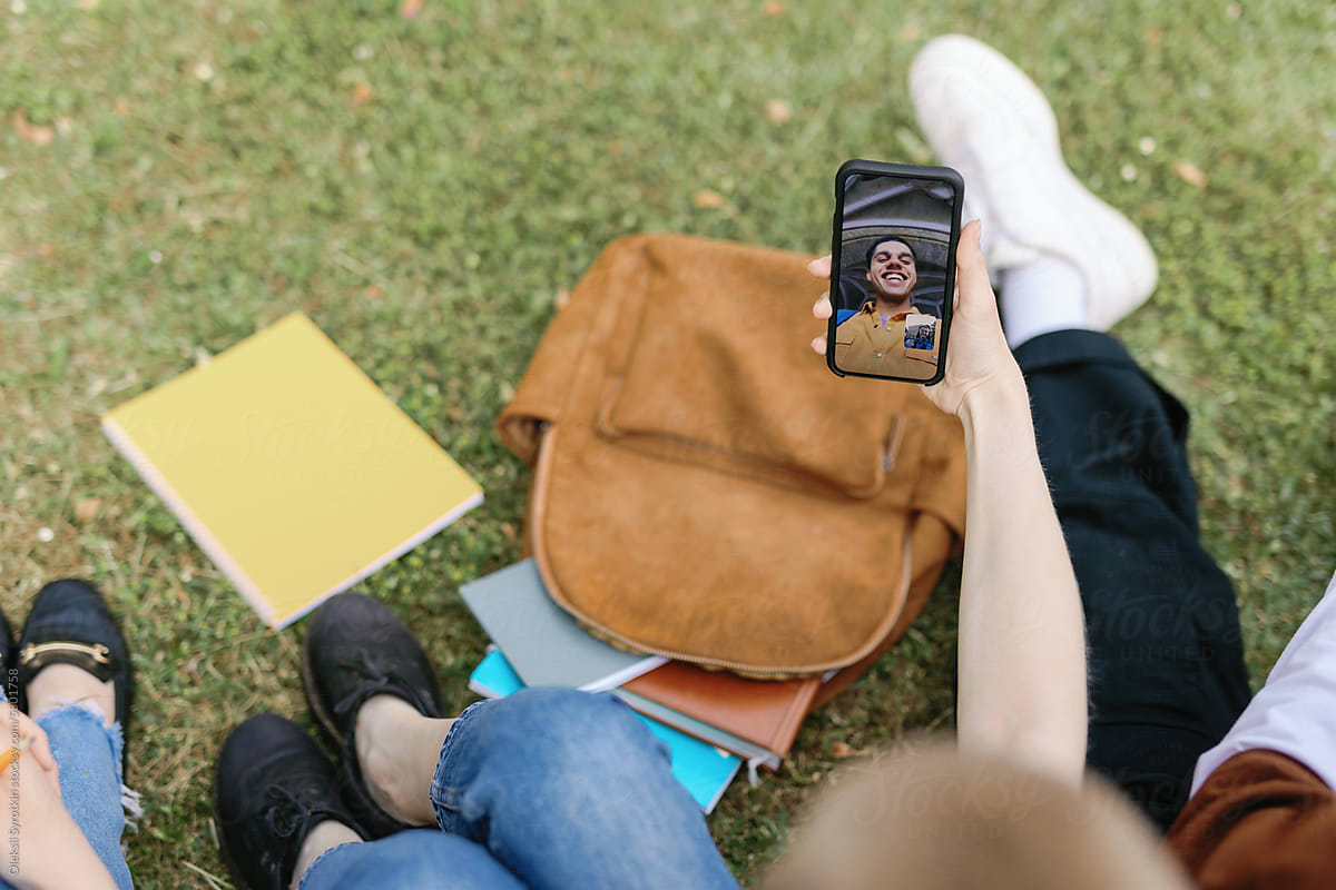 Anonymous student gadget app lawn nature FaceTime conversation online