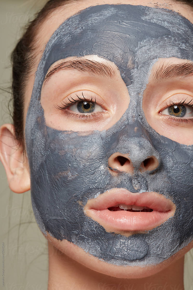 Confident woman with clay mask