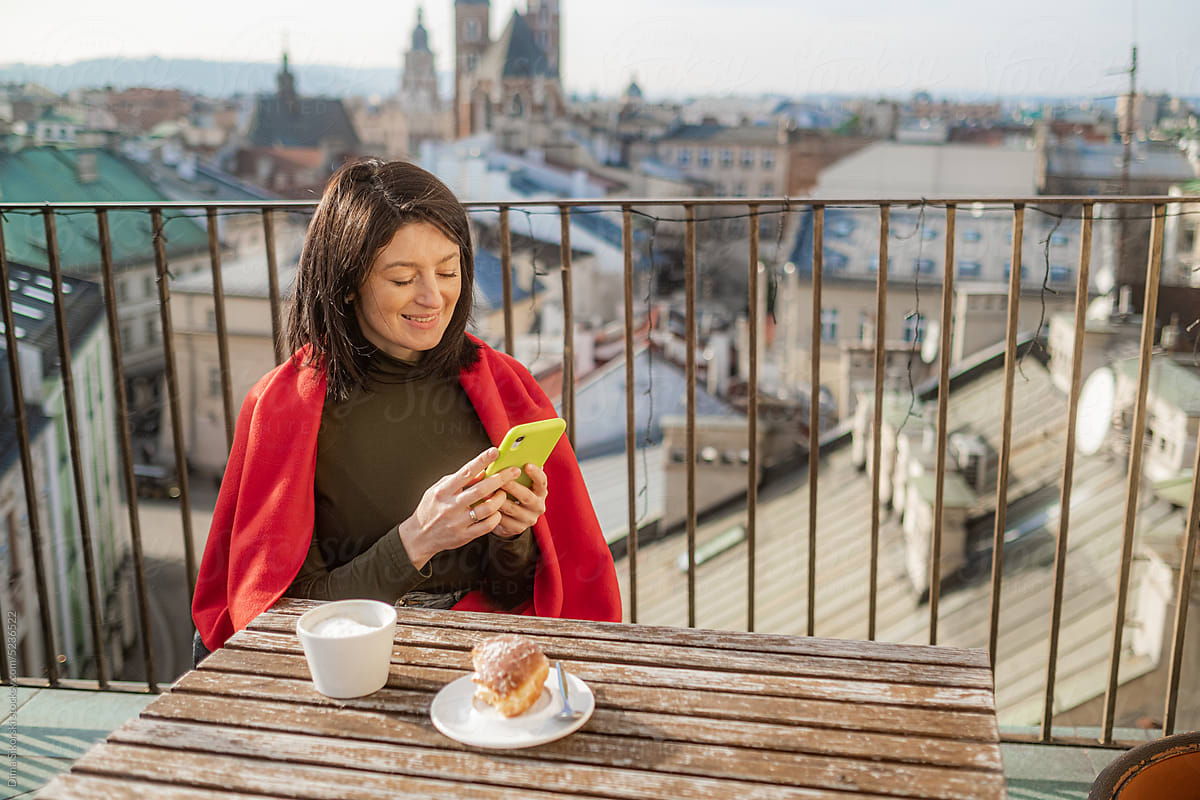 Smiling girl with smartphones in a beautiful European city