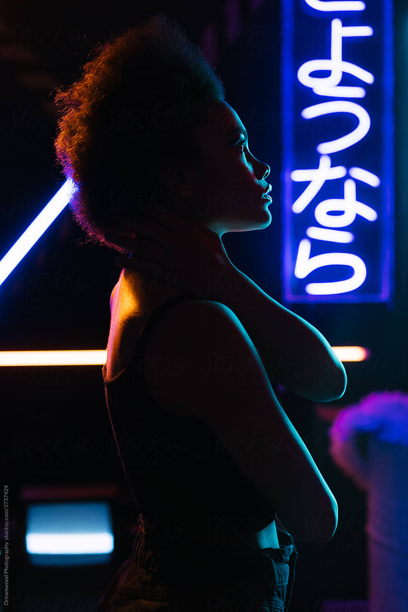 Black female model in neon illumination