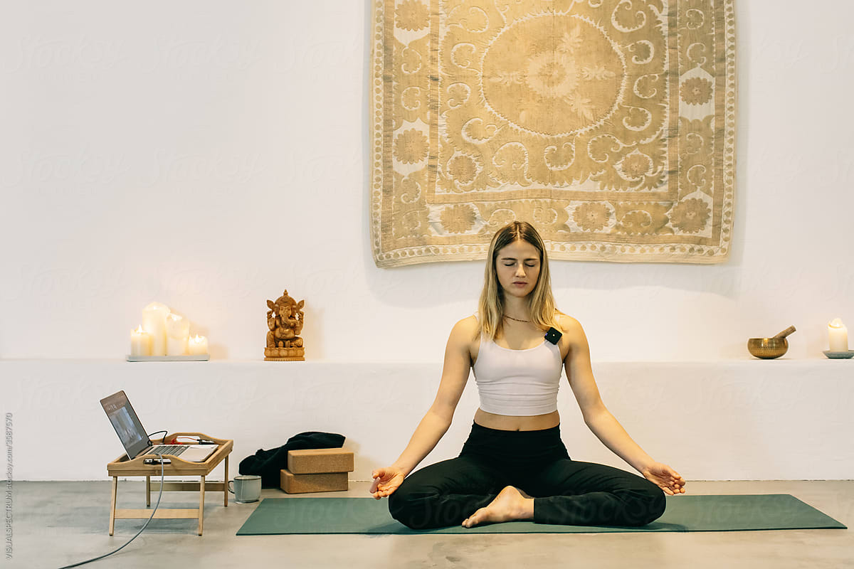 Female Yoga Instructor Teaching Online Meditation Class During Lockdown