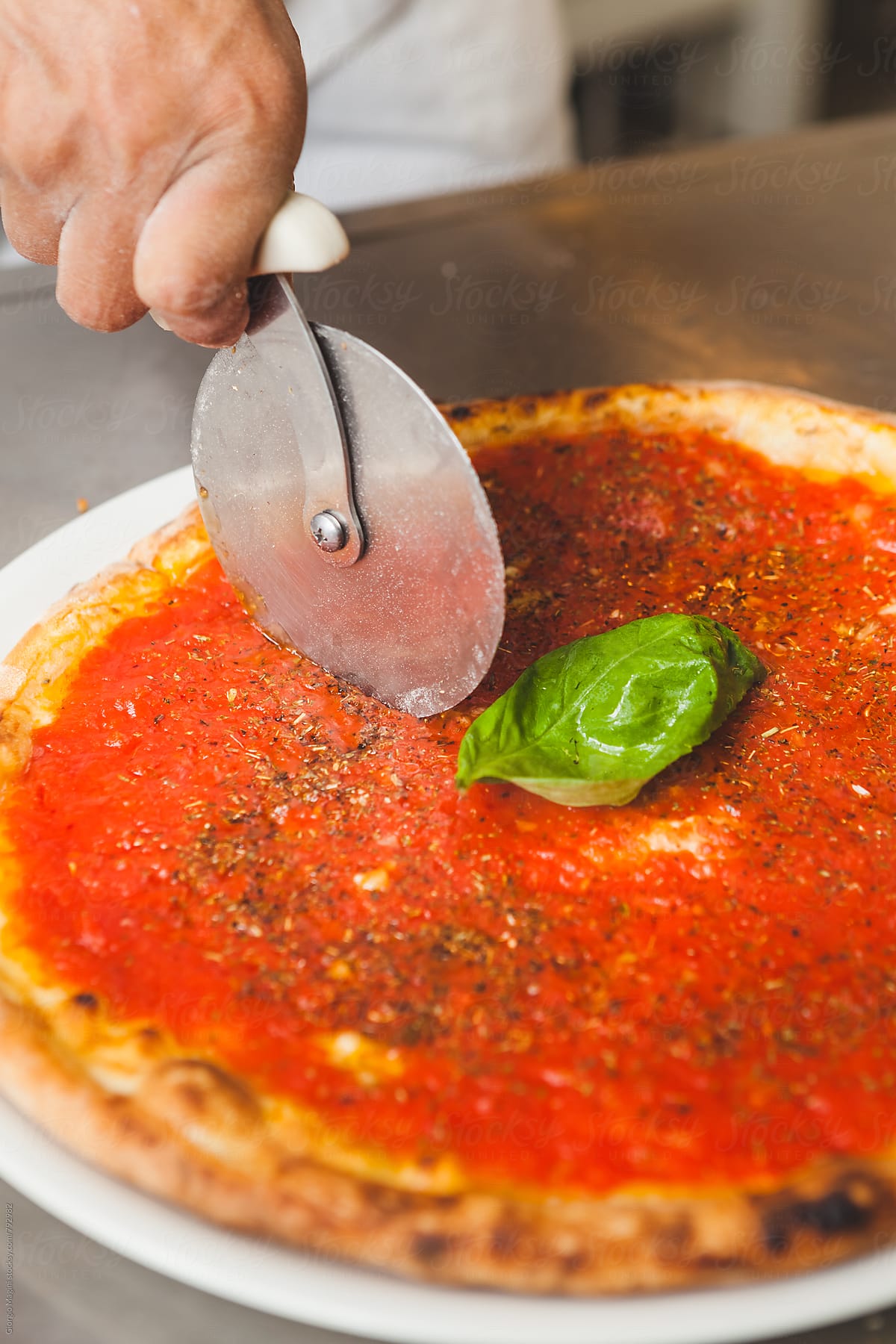 Marinara Pizza being Cut with a Wheel